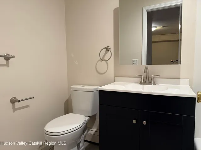 a bathroom with a sink mirror toilet and vanity