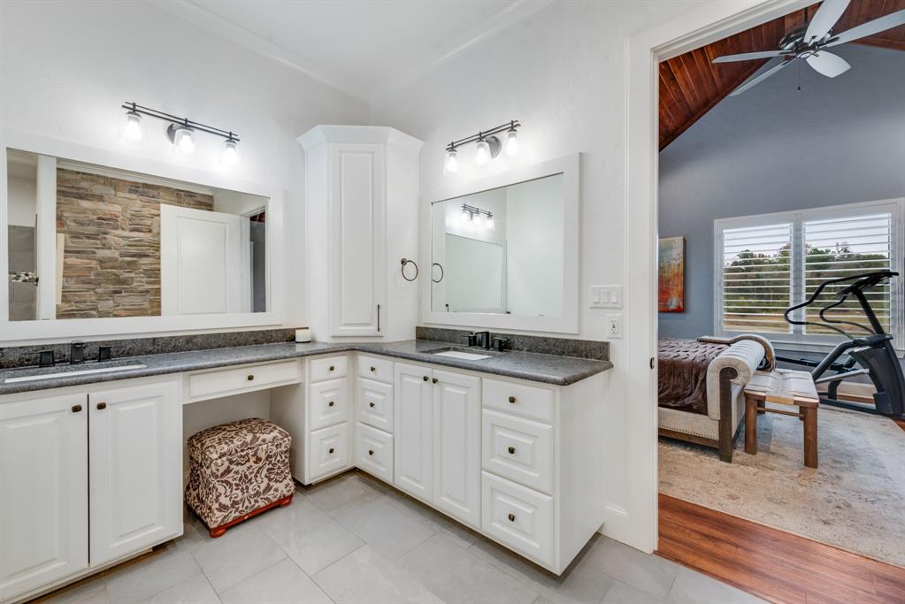 10794 County Road 334 Tyler, TX 75708 - Photo 23 of 40 a spacious bathroom with a granite countertop sink and a mirror