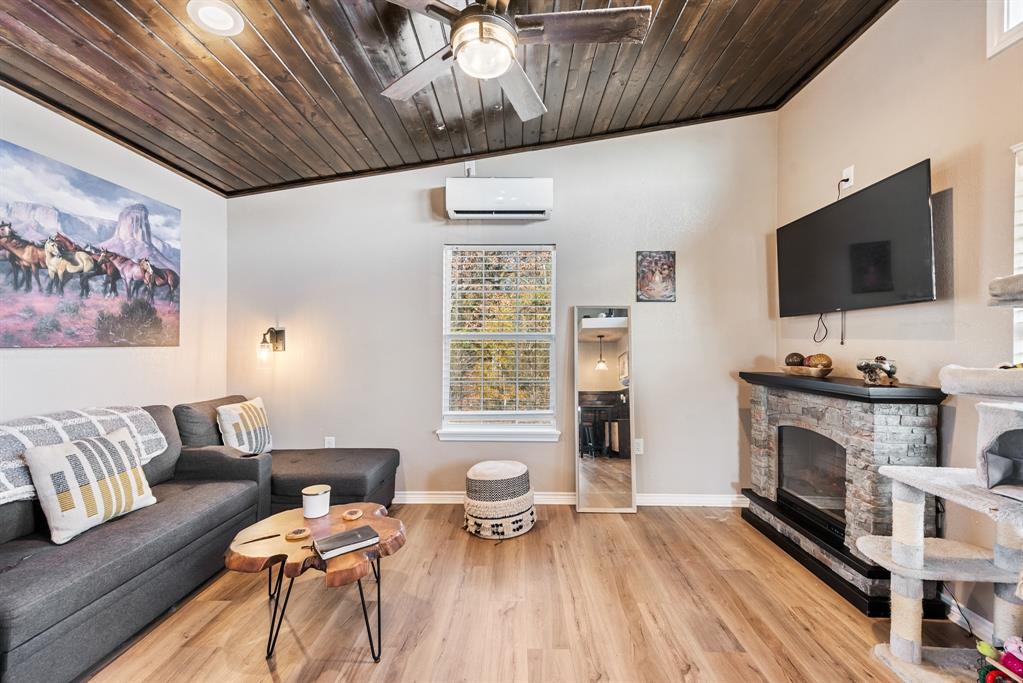 10794 County Road 334 Tyler, TX 75708 - Photo 27 of 40 a living room with furniture a flat screen tv and a fireplace