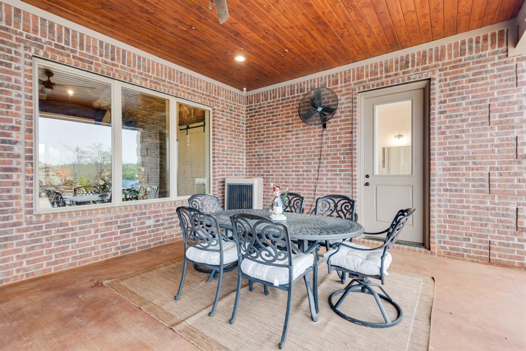 10794 County Road 334 Tyler, TX 75708 - Photo 32 of 40 a patio with table and chairs and potted plants