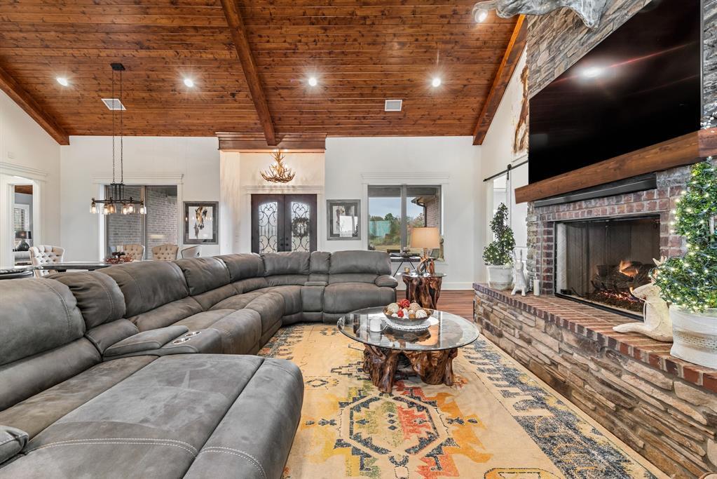 10794 County Road 334 Tyler, TX 75708 - Photo 8 of 40 a living room with furniture a fireplace and a flat screen tv