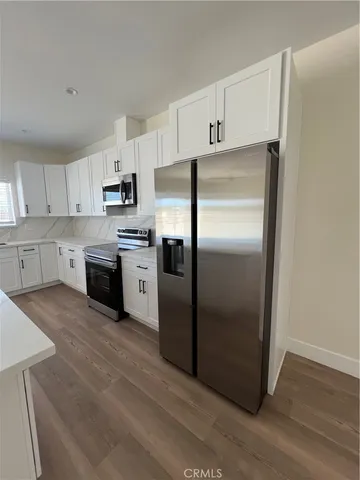 a kitchen with stainless steel appliances a refrigerator sink and microwave