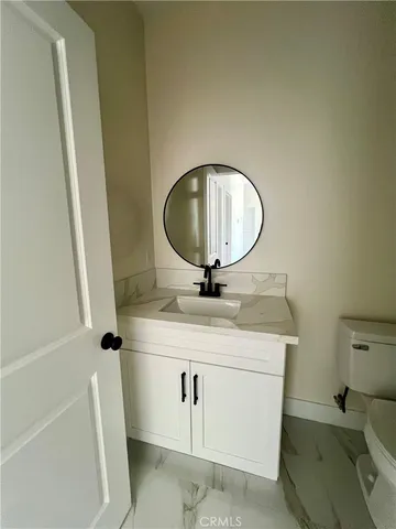 a bathroom with a sink mirror and vanity