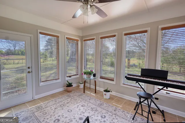 a dining room with furniture a rug and a large window