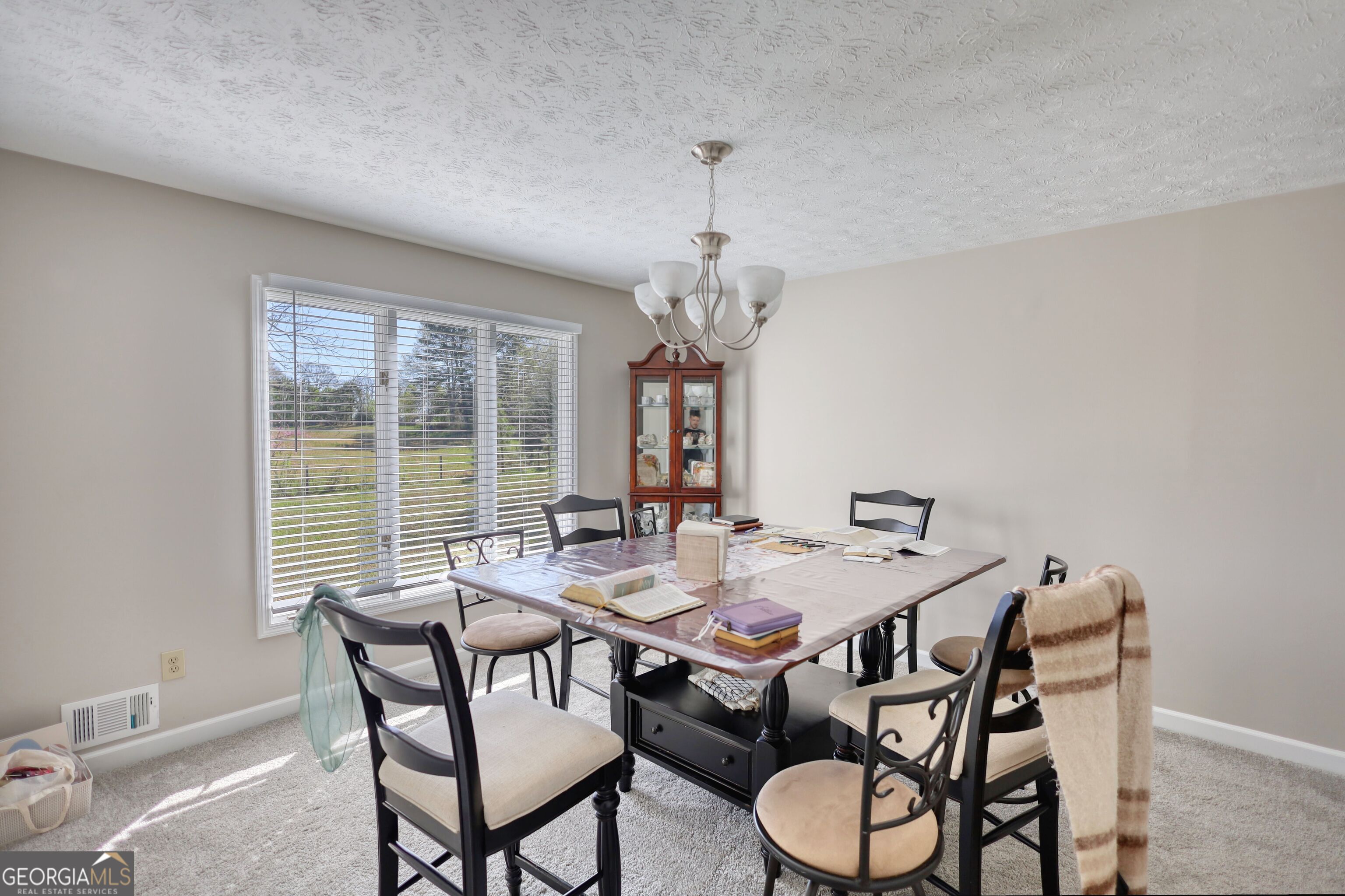 610 Loth Wages Road Dacula, GA 30019 - Photo 16 of 70 a view of a dining room with furniture wooden floor and chandelier