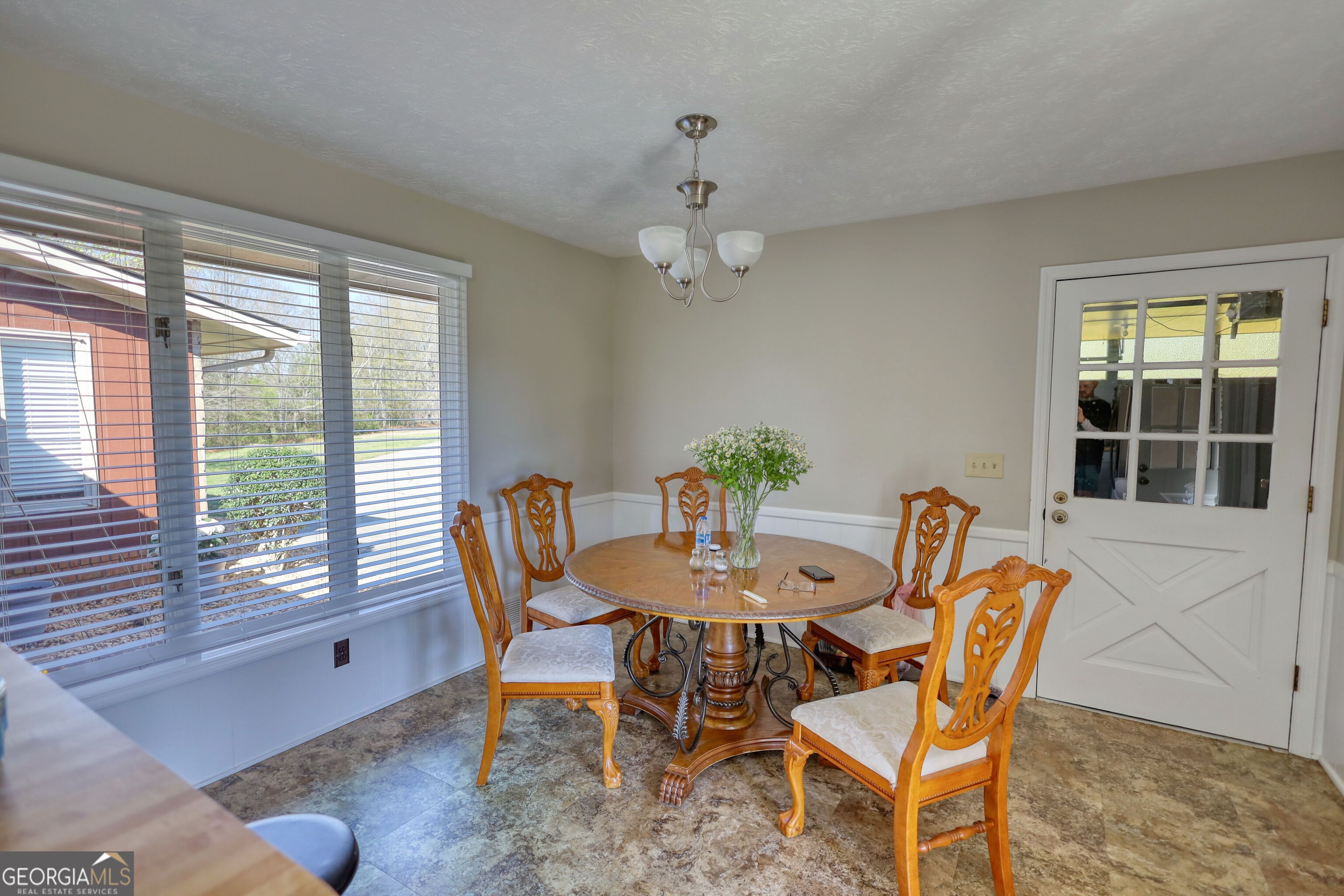 610 Loth Wages Road Dacula, GA 30019 - Photo 19 of 70 a dining room with furniture a rug and a large window