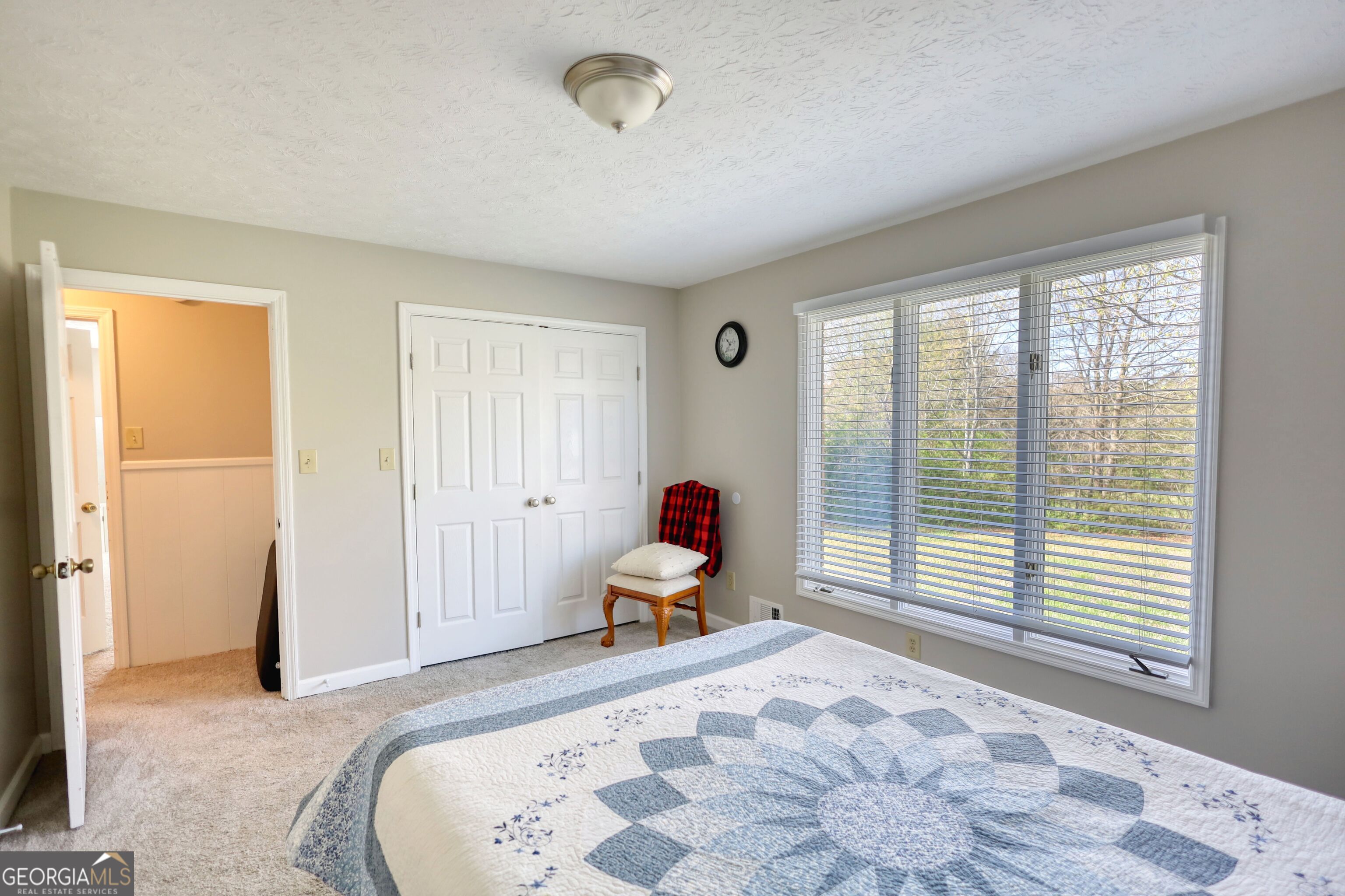 610 Loth Wages Road Dacula, GA 30019 - Photo 23 of 70 a bedroom with a bed and wooden floor