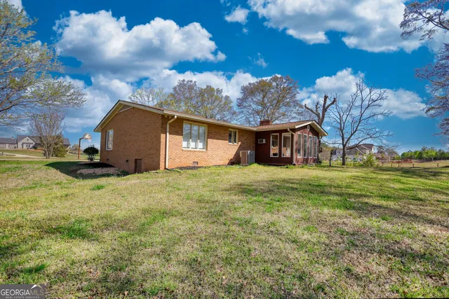 an aerial view of a tennis ground and large trees