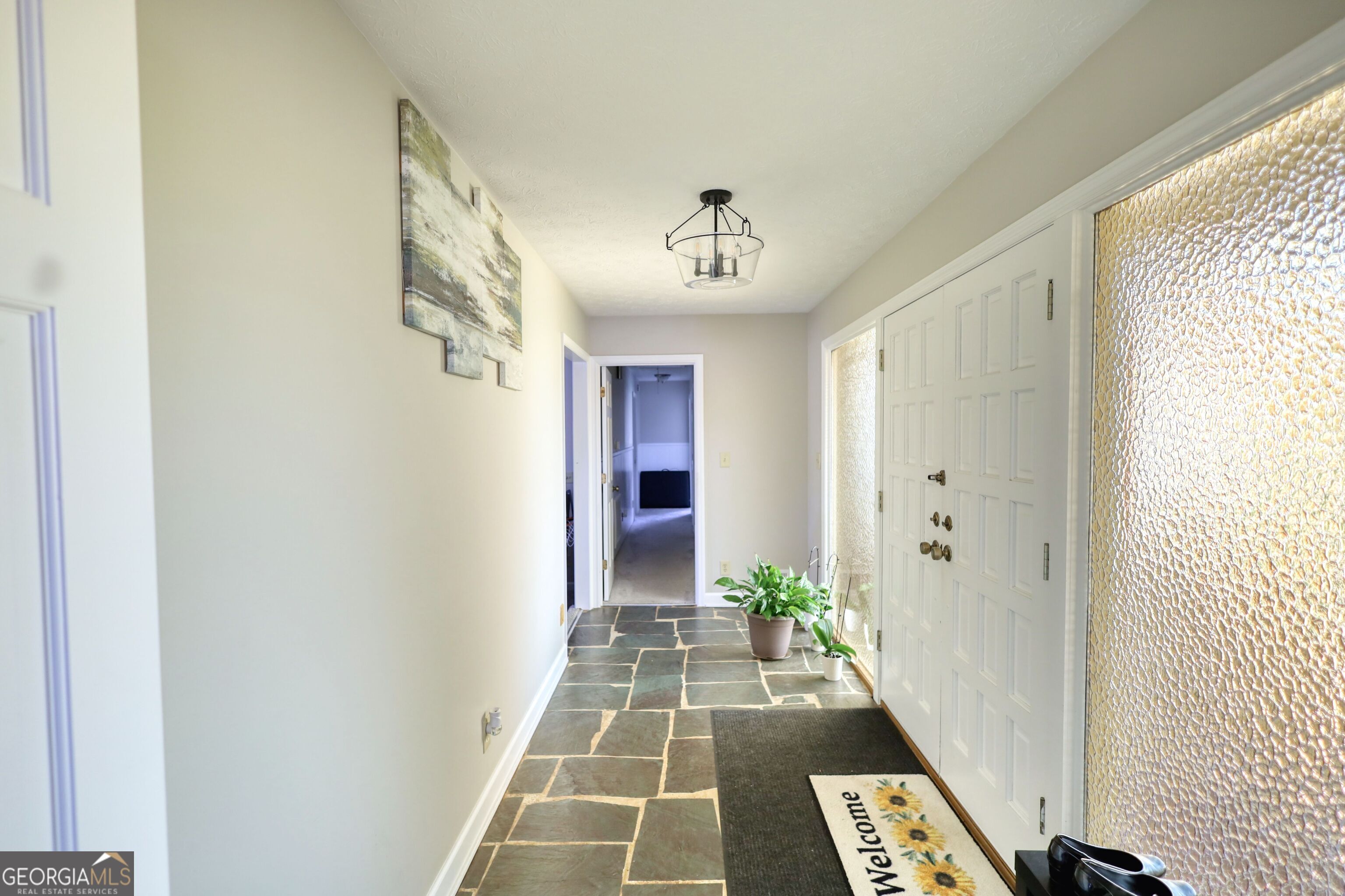 610 Loth Wages Road Dacula, GA 30019 - Photo 10 of 70 a view of a hallway with wooden floor and a dining room