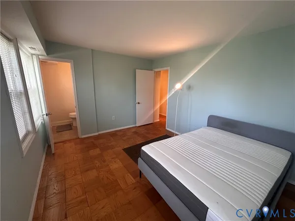 a bedroom with two beds and a window