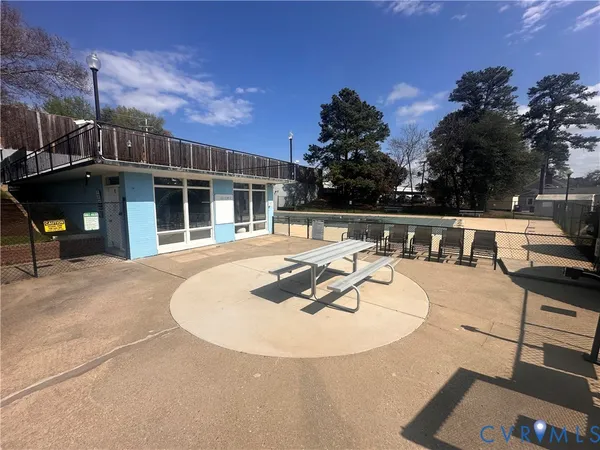a view of a house with swimming pool and sitting area