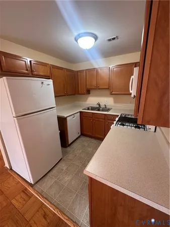 a kitchen with stainless steel appliances a refrigerator sink and microwave