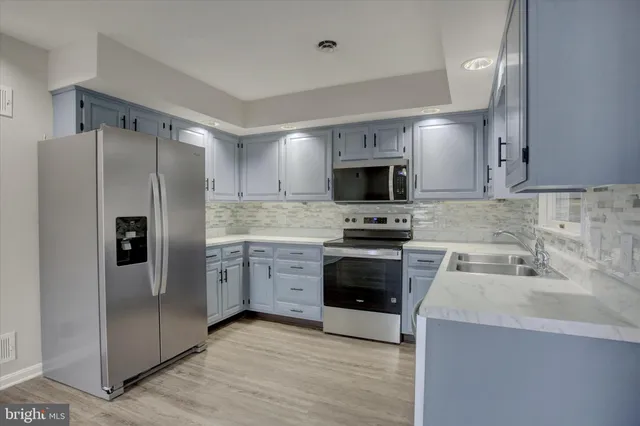 a kitchen with a refrigerator stove and sink