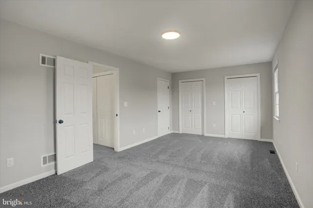 a view of an empty room and closet area