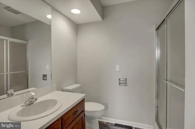 a bathroom with a sink toilet and a mirror