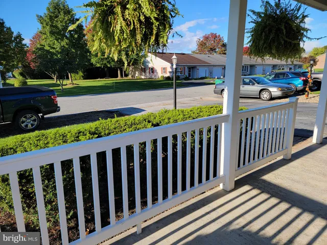 a view of a wooden deck and a backyard