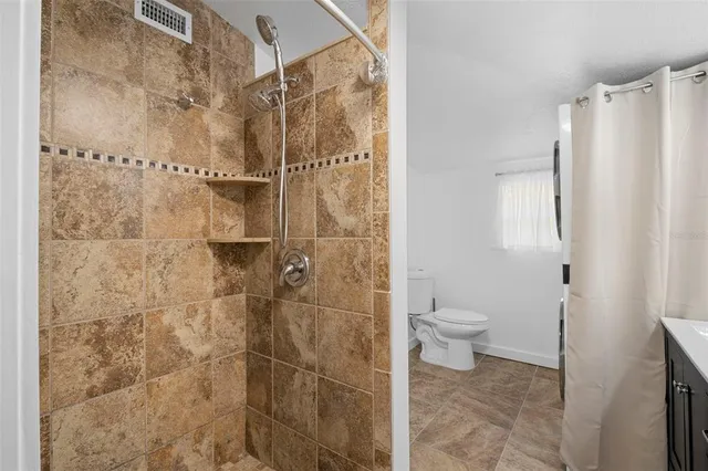 a bathroom with a toilet and shower