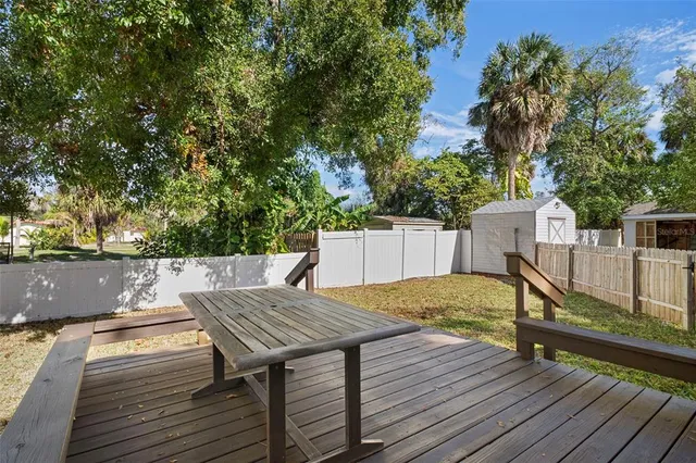 a view of backyard with a deck and wooden floor