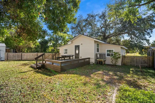 a view of a house with a yard and sitting area