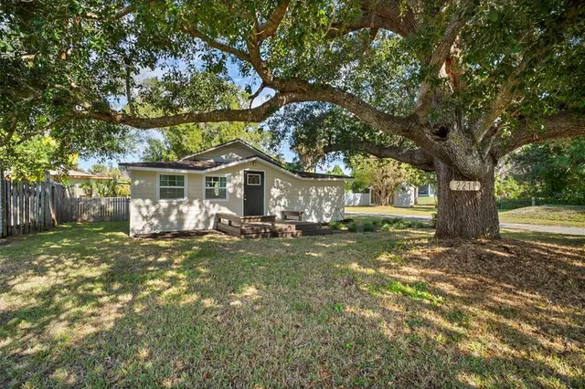 a front view of a house with yard patio and green space
