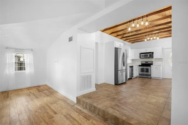 a view of kitchen and refrigerator