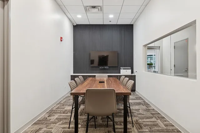 a view of a dining room with furniture and a rug