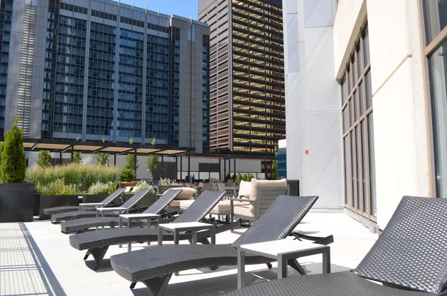 a view of a patio with table and chairs and potted plants