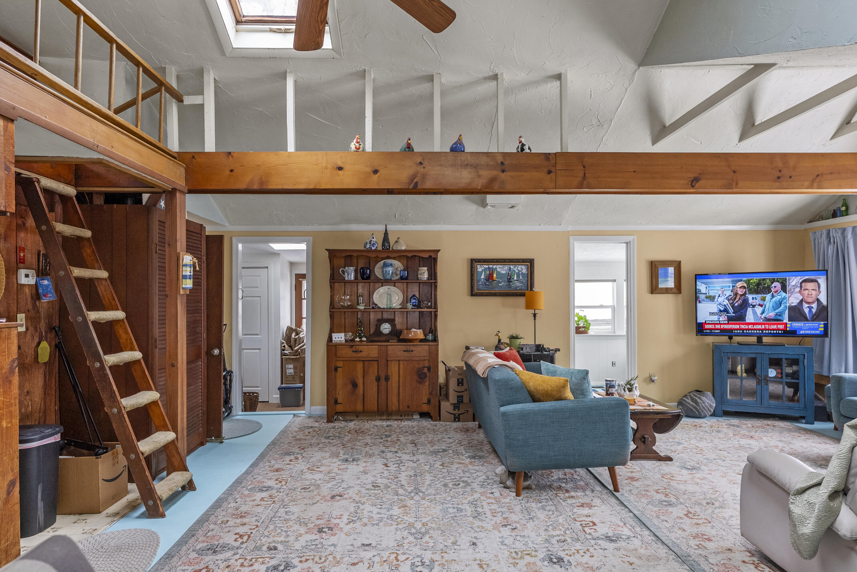 24 E Road Mashpee, MA 02649 - Photo 22 of 43 a living room with furniture a flat screen tv and gym equipment