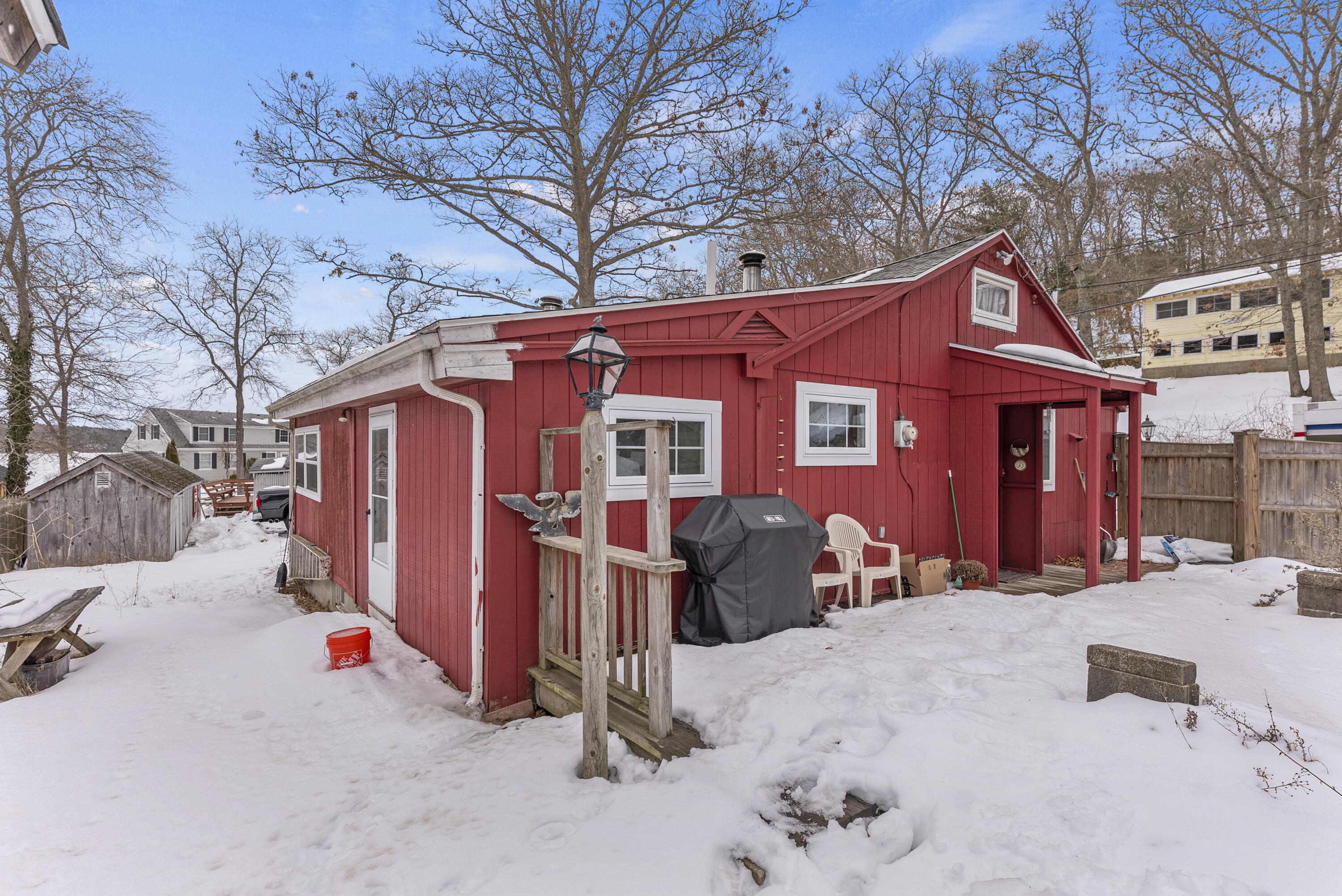 24 E Road Mashpee, MA 02649 - Photo 4 of 43 a view of a house with a yard covered in snow