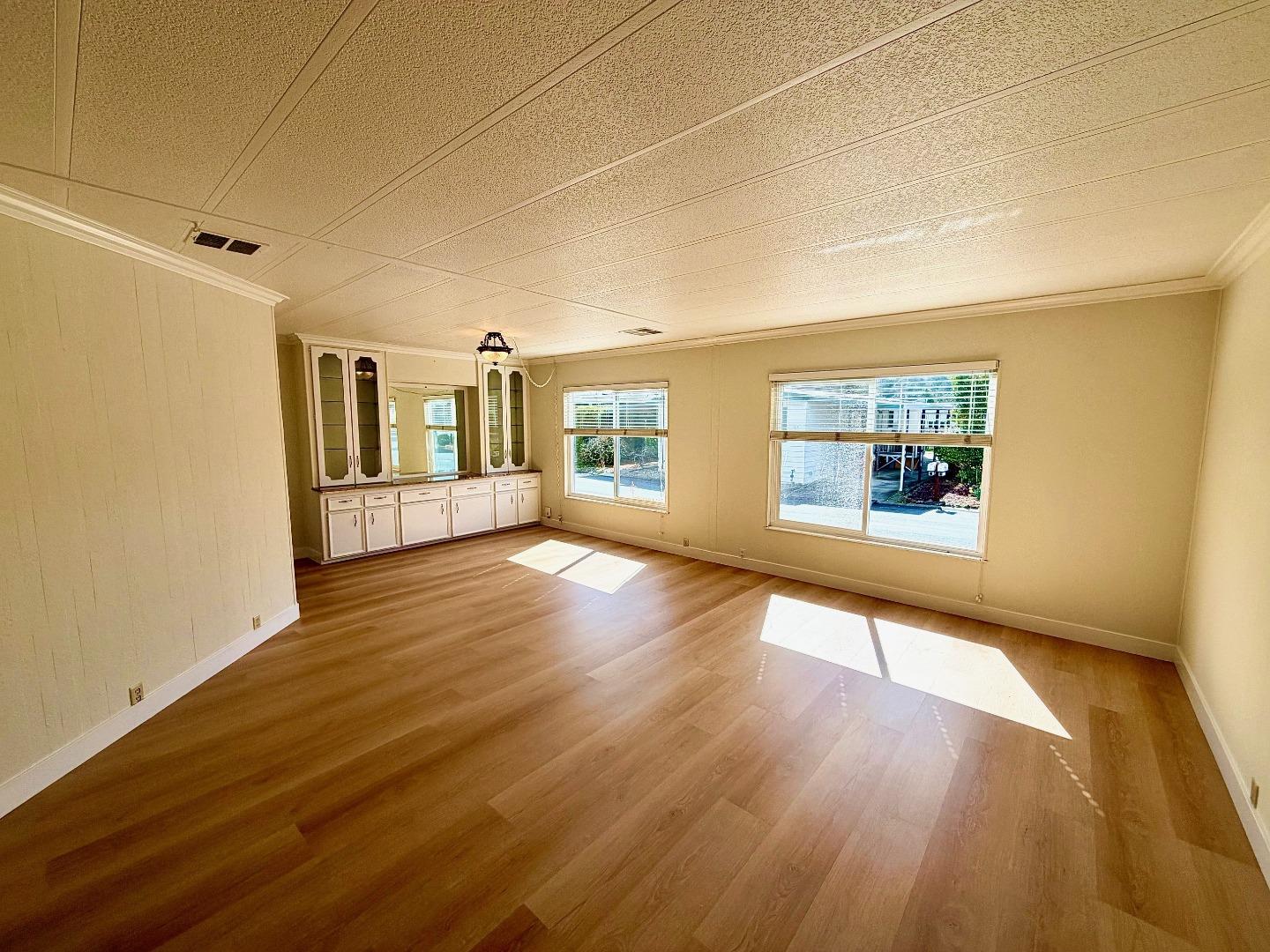 225 Mt Hermon Road, Unit 217 Scotts Valley, CA 95066 - Photo 2 of 29 an empty room with wooden floor and windows