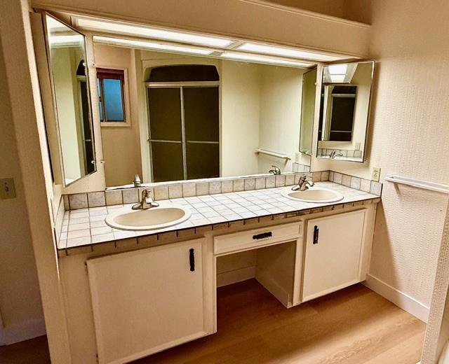 225 Mt Hermon Road, Unit 217 Scotts Valley, CA 95066 - Photo 23 of 29 a bathroom with a double vanity sink and a mirror