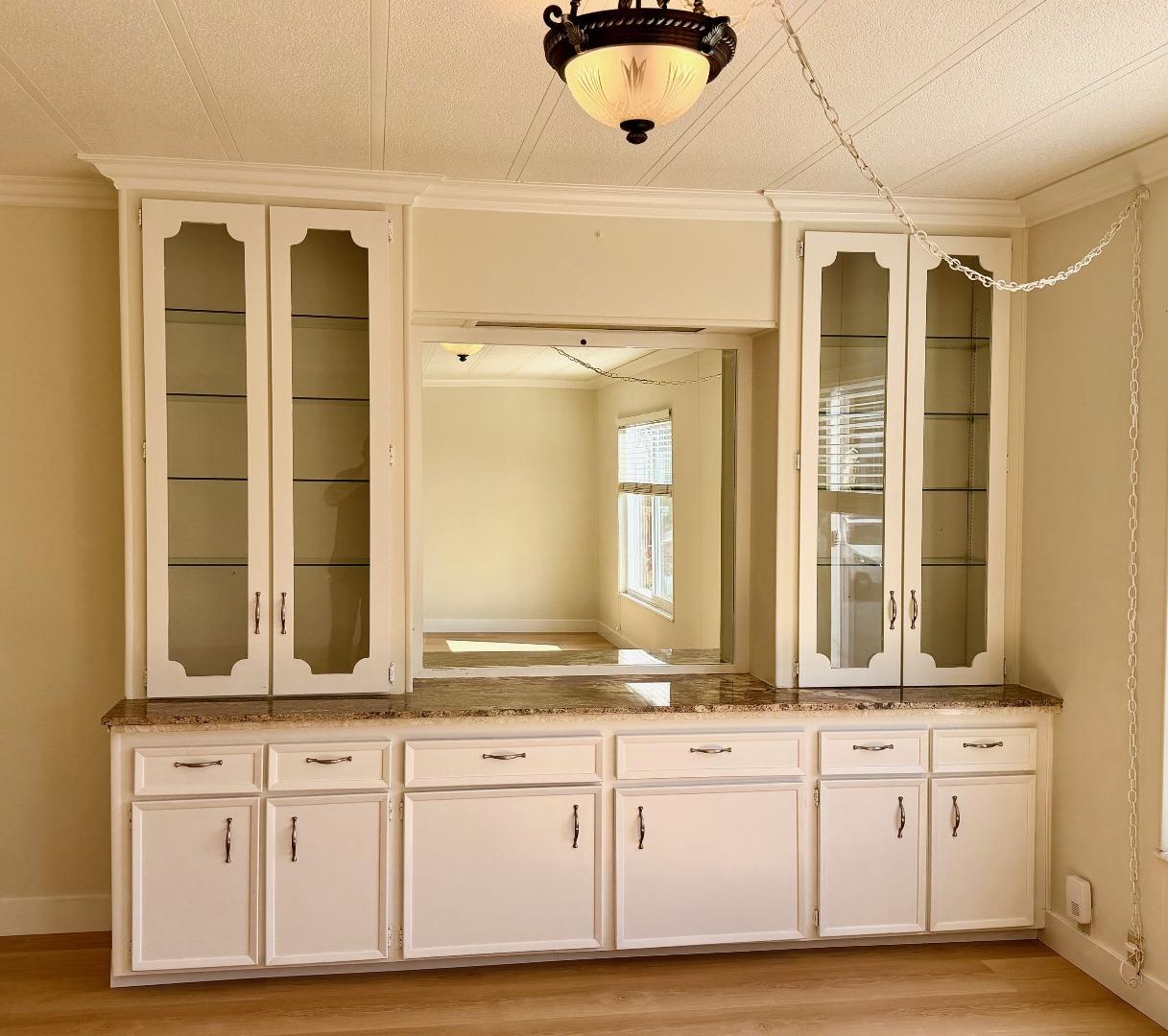 225 Mt Hermon Road, Unit 217 Scotts Valley, CA 95066 - Photo 4 of 29 a bathroom with a granite countertop sink and a mirror