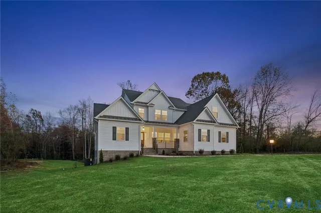a living room with furniture a large window and a chandelier