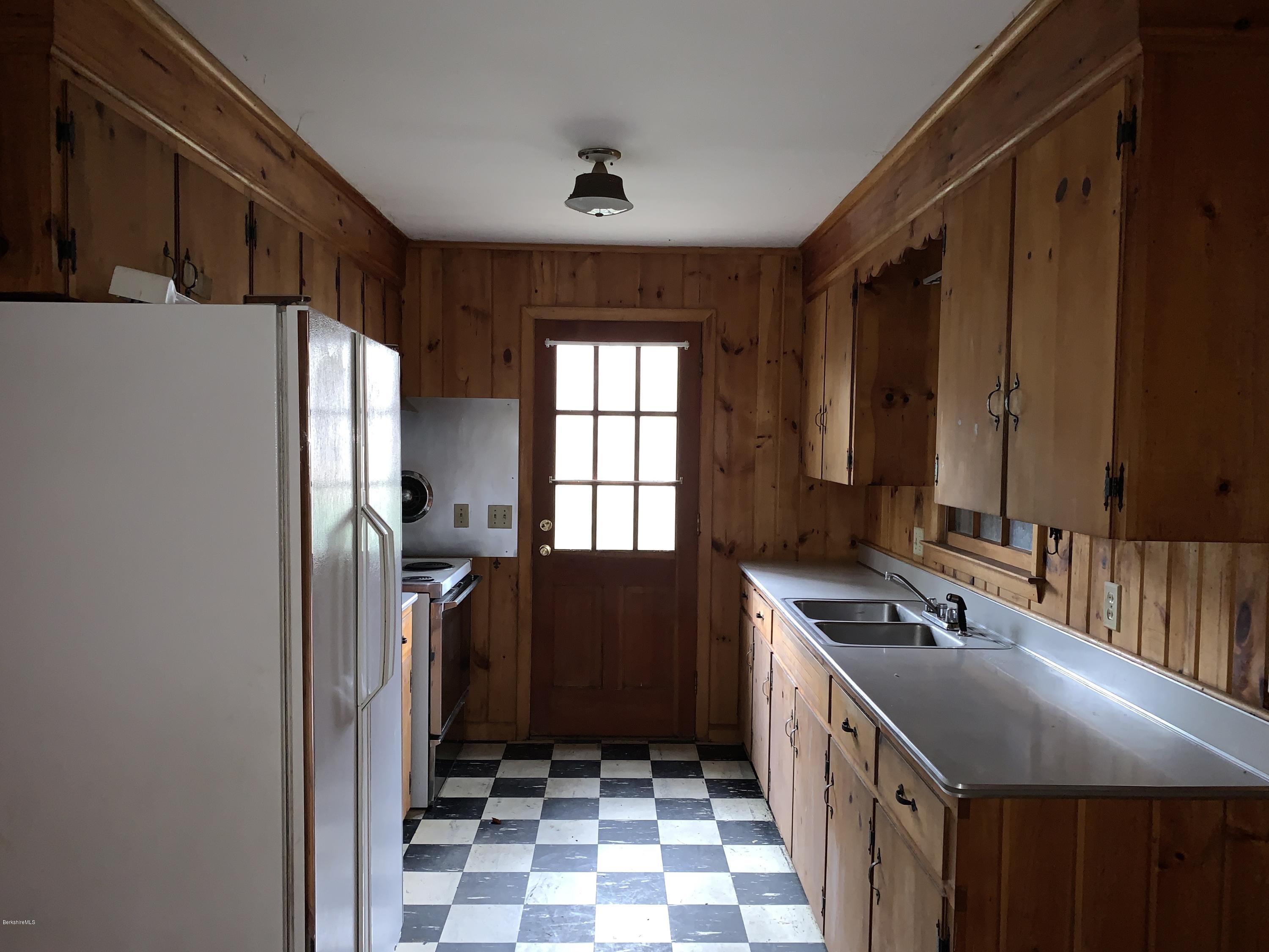 21 Point Road Monterey, MA 01245 - Photo 12 of 25 a kitchen with a sink stove and refrigerator