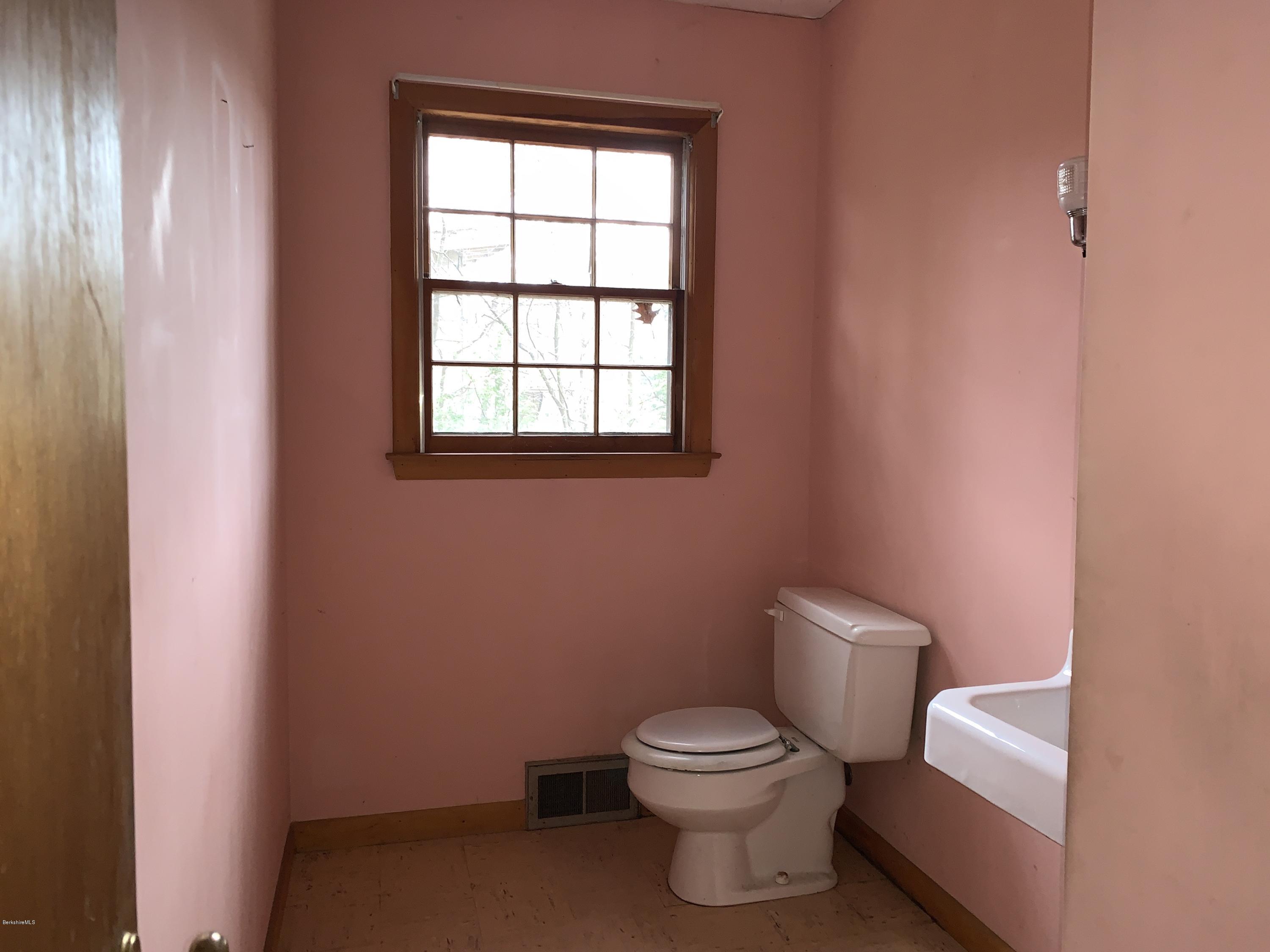 21 Point Road Monterey, MA 01245 - Photo 15 of 25 a white toilet sitting next to a bathroom sink
