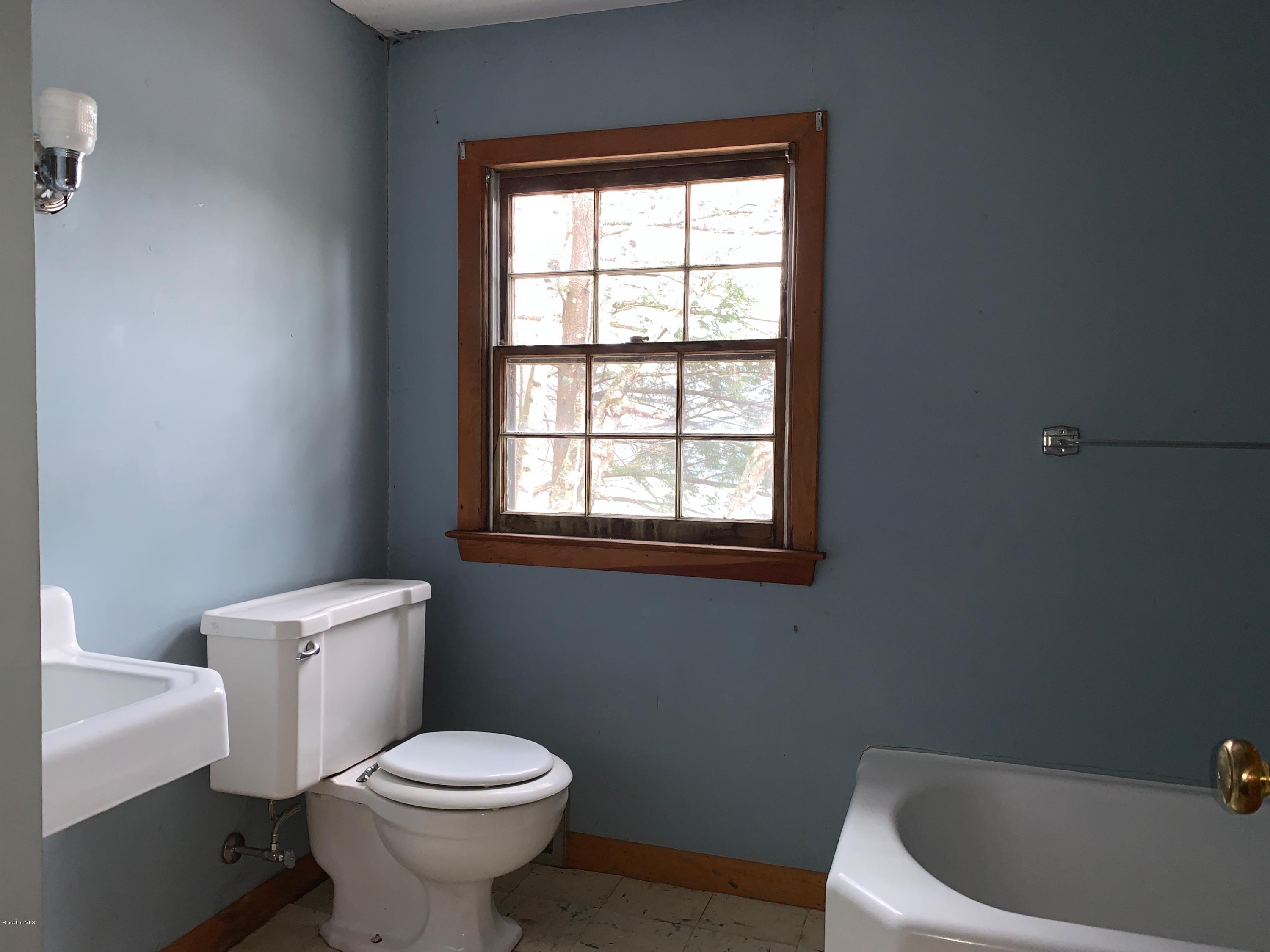 21 Point Road Monterey, MA 01245 - Photo 18 of 25 a white toilet sitting next to a window