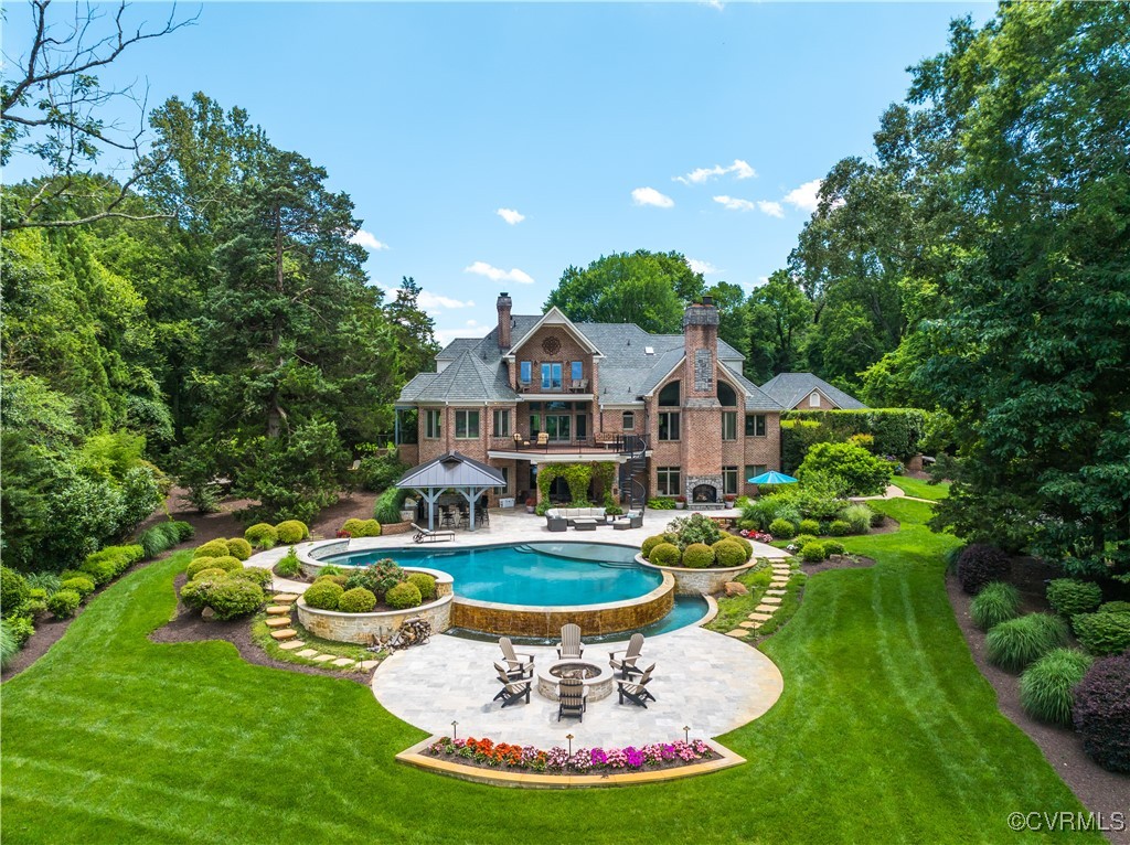 a swimming pool with outdoor seating and yard