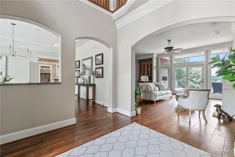 a spacious bedroom with a bed and wooden floor