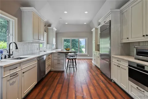 a bathroom with a granite countertop sink a mirror and a shower