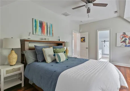 an aerial view of a house with a swimming pool and large trees