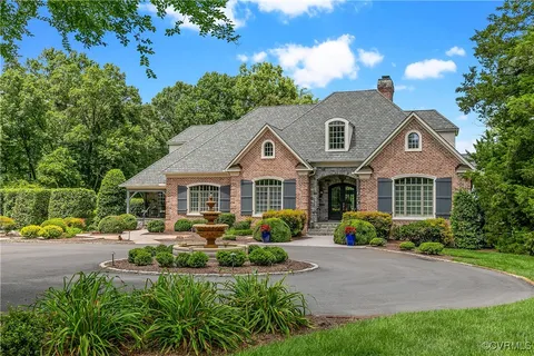 a house that has a yard plants and large tree