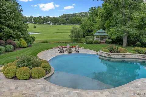 a living room with furniture fireplace and a large window