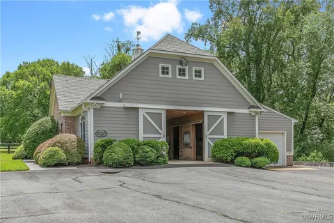 a kitchen with stainless steel appliances granite countertop a stove a sink dishwasher and a dining table with wooden floor