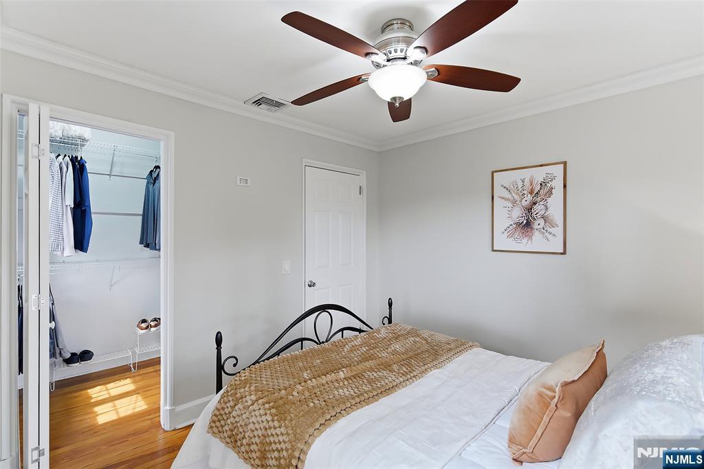 31 Martin Terrace Hackensack, NJ 07601 - Photo 19 of 32 a bedroom with a bed and a chandelier