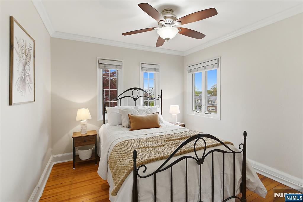 31 Martin Terrace Hackensack, NJ 07601 - Photo 20 of 32 a bedroom with a bed and a chandelier