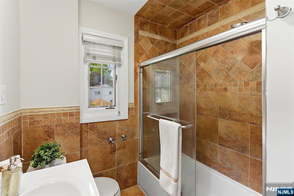31 Martin Terrace Hackensack, NJ 07601 - Photo 22 of 32 a bathroom with a shower and a sink