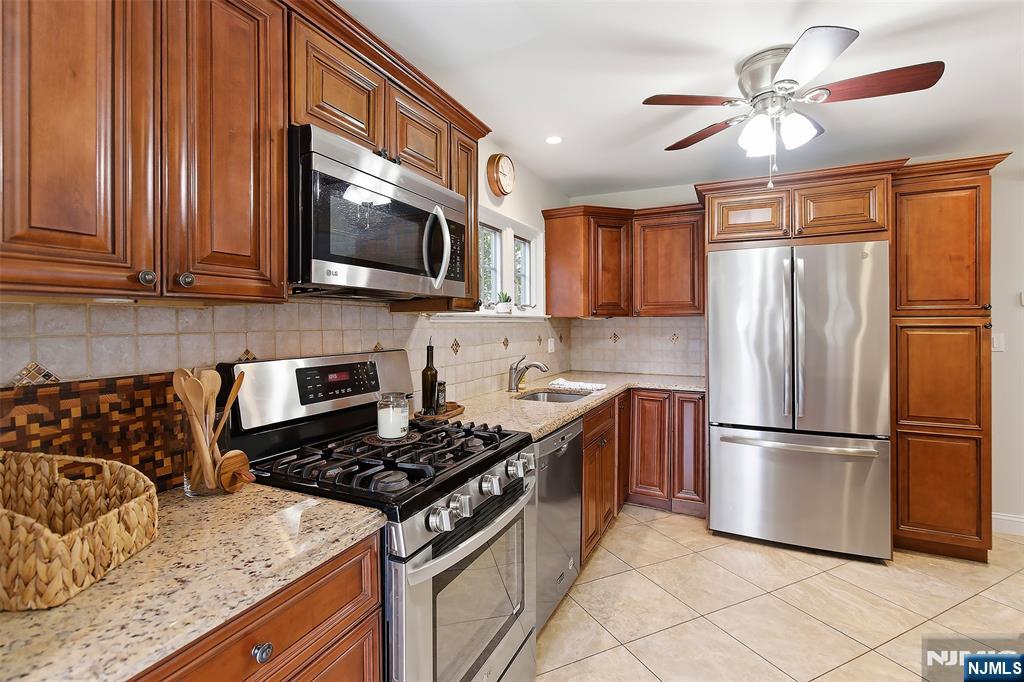 31 Martin Terrace Hackensack, NJ 07601 - Photo 10 of 32 a kitchen with stainless steel appliances granite countertop a stove top oven a sink and a refrigerator