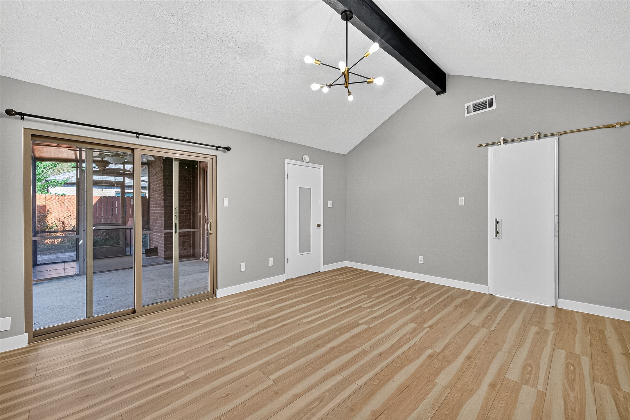 2026 Ashford Hollow Lane Houston, TX 77077 - Photo 12 of 35 a view of an empty room with wooden floor and a window