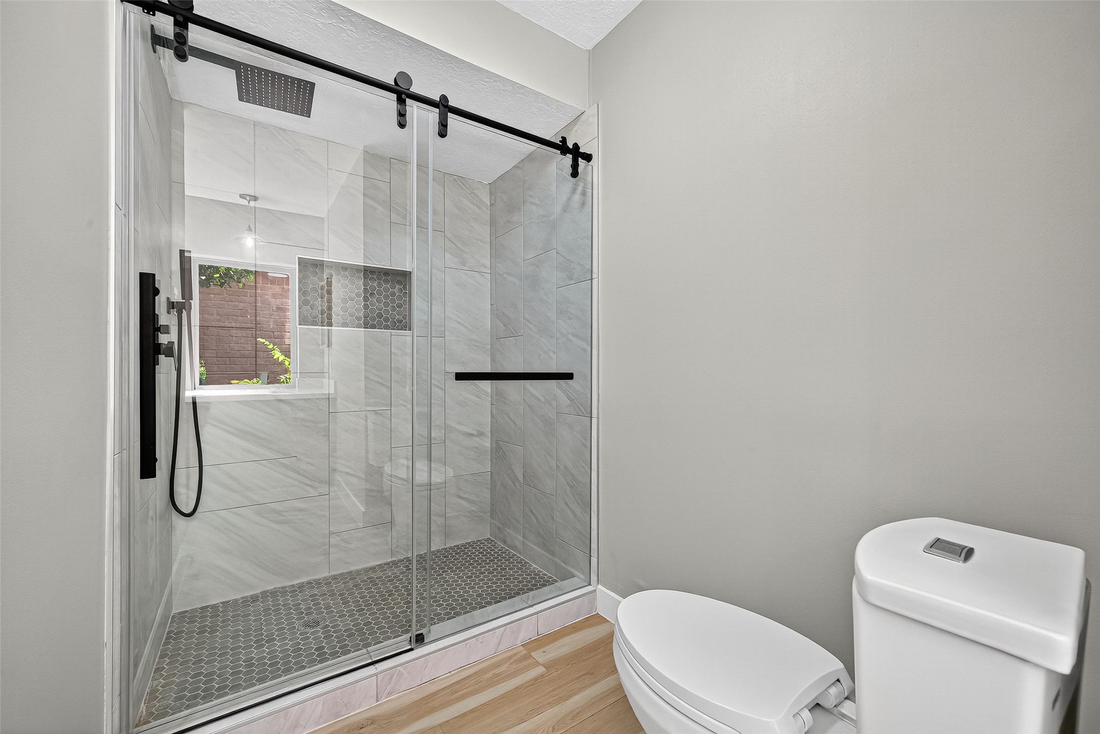 2026 Ashford Hollow Lane Houston, TX 77077 - Photo 16 of 35 a bathroom with a shower and toilet