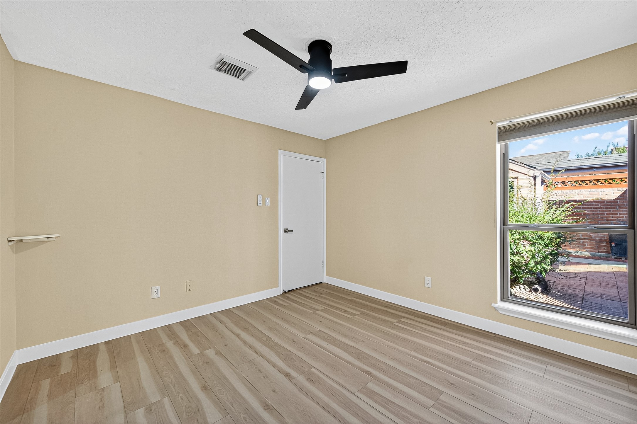 2026 Ashford Hollow Lane Houston, TX 77077 - Photo 19 of 35 a view of a room with wooden floor and a ceiling fan